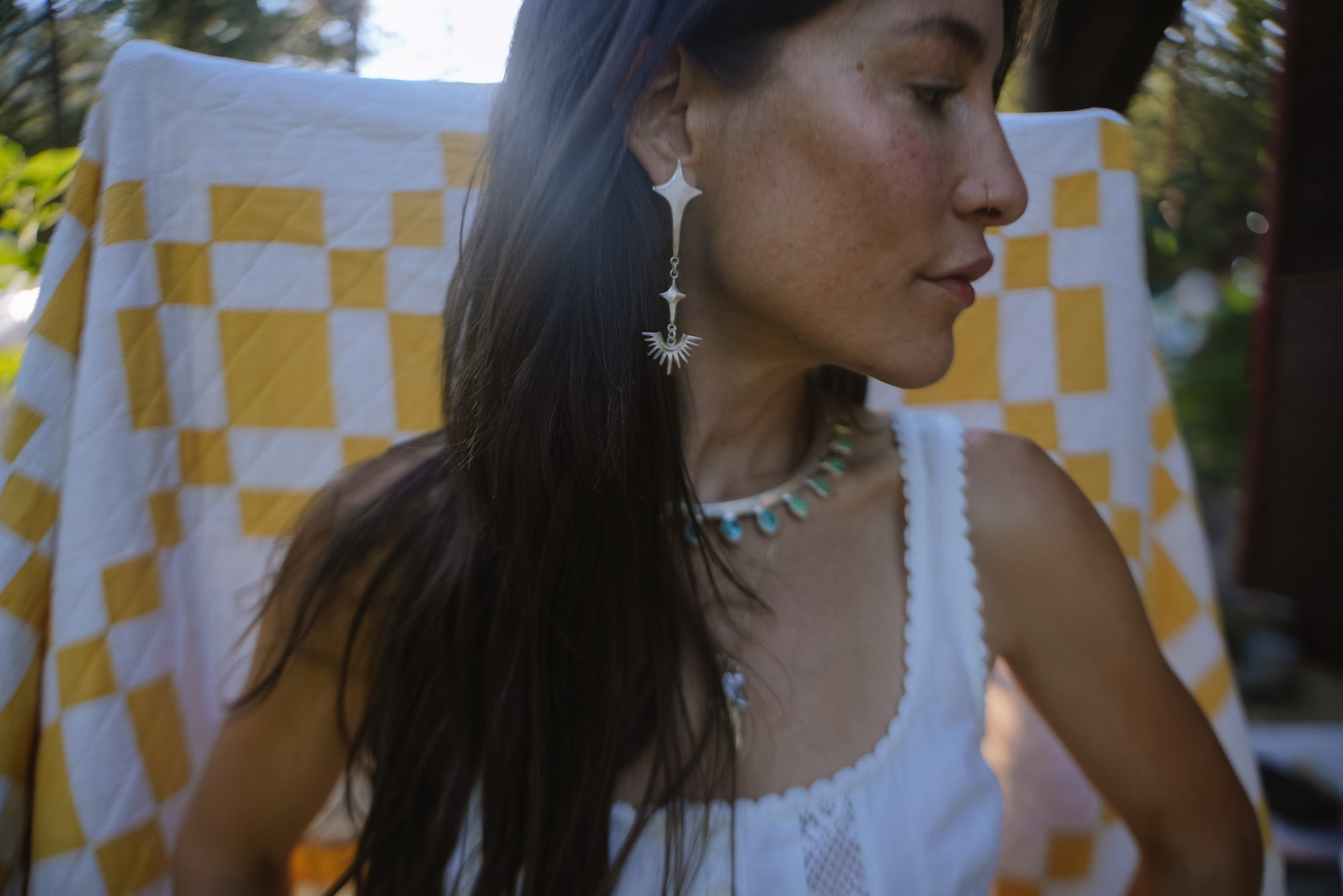 Reclaimed asymmetrical sterling silver post earrings. Stars and horizon line symbols dangle from the larger star at the top.